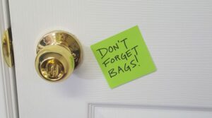 Post-it note reminder on door, so to remember reusable bags.